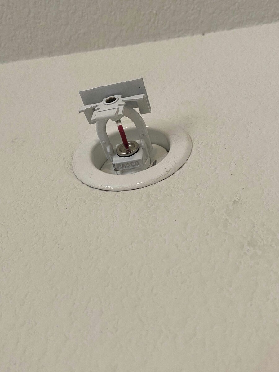 Newly installed unpainted fire sprinkler head, ready to operate at its listed activation temperature