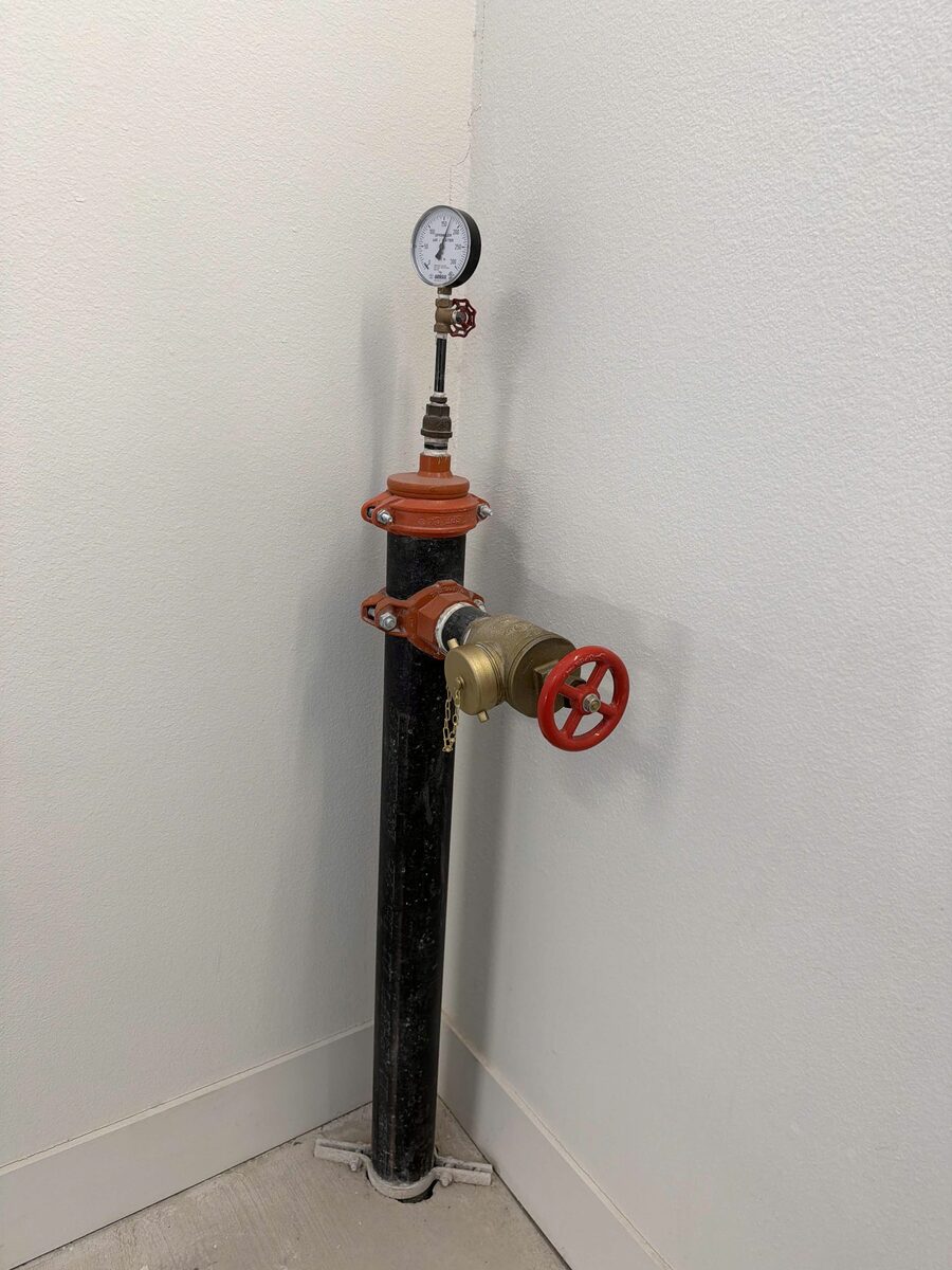 Standpipe hose valve in a stairwell with a new brass cap