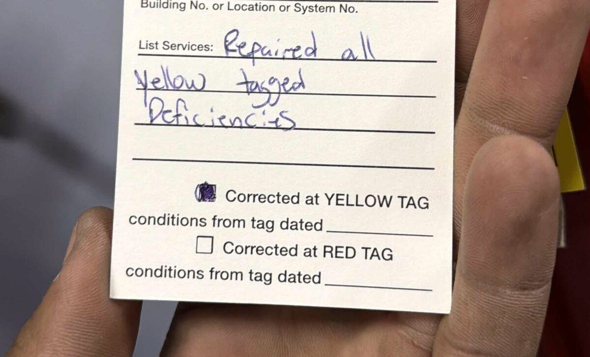 Paragon service tag reading 'repaired all yellow tagged deficiencies' with the corrected-at-yellow-tag box checked