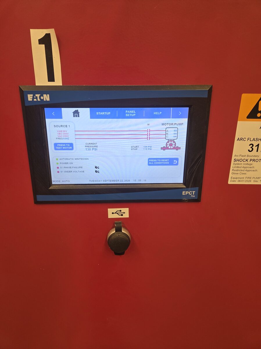 Fire pump controller touchscreen on the controller cabinet, with its arc flash warning label