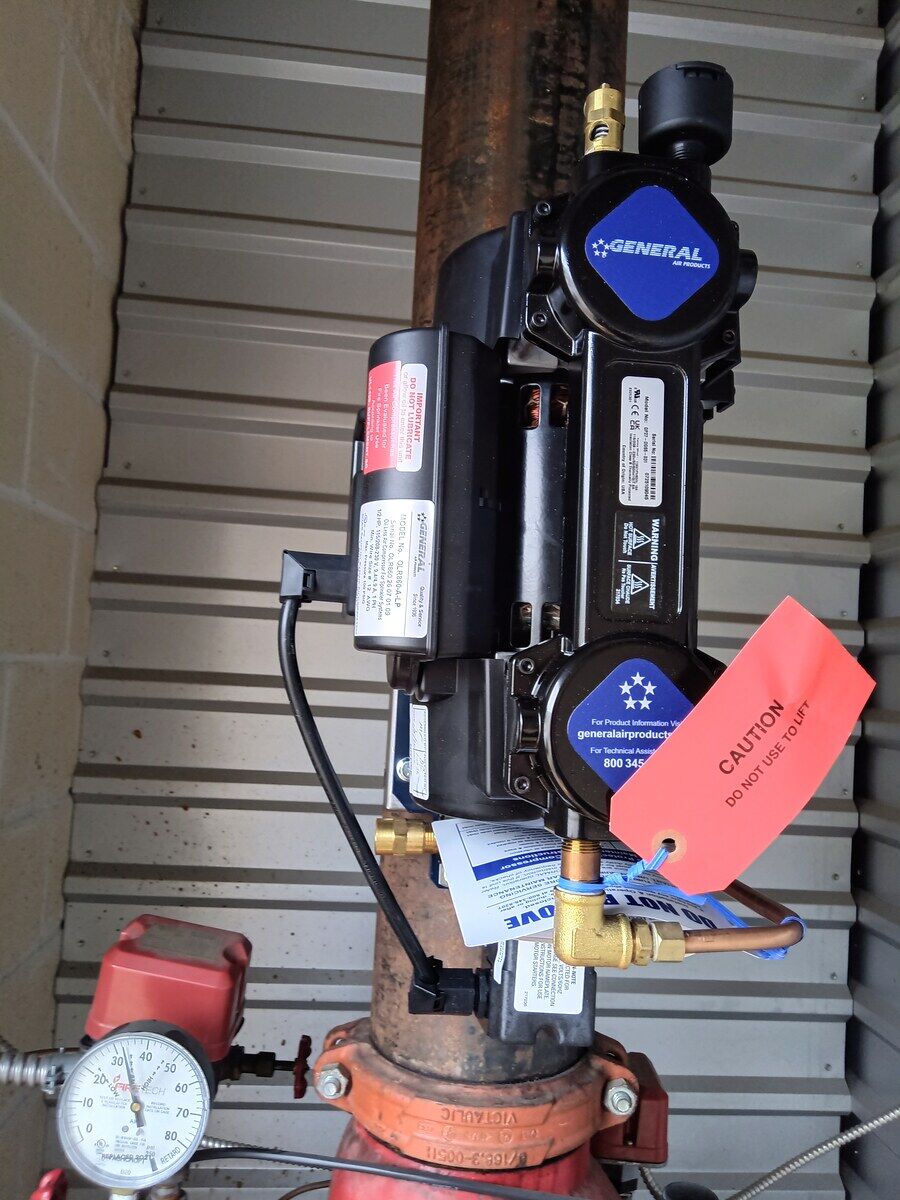 After: properly listed riser-mounted compressor installed to spec