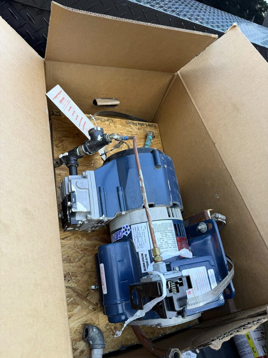 The failed 1/3 HP dry-system air compressor after removal from the apartment building's fire-sprinkler riser